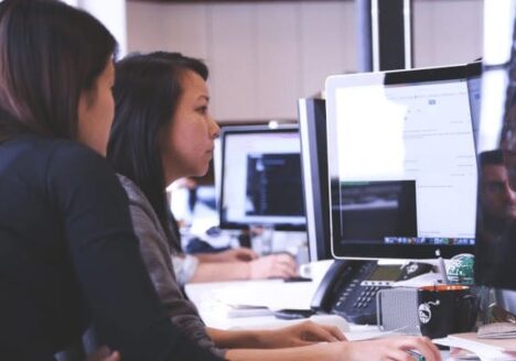 People sitting at a computer working